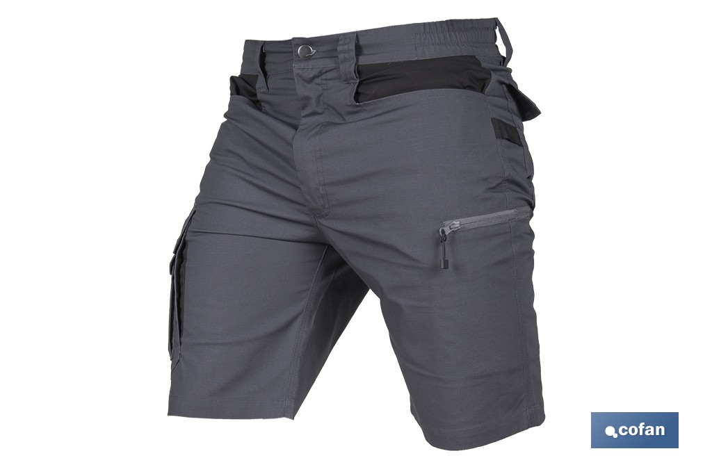 Bermudas de trabajo modelo Frigg en gris y negro | Elásticas, ligeras con múltiples bolsillos y protección lumbar| Materiales: 65 % poliéster y 32 % algodón | Disponibles en amplio rango de tallas - Cofan