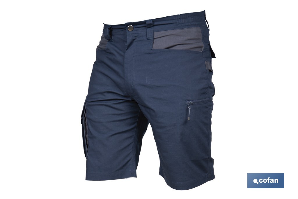 Bermudas de trabajo modelo Tyr en azul marino y negro | Elásticas, ligeras con múltiples bolsillos y protección lumbar| Materiales: 65 % poliéster y 32 % algodón | Disponibles en amplio rango de tallas - Cofan