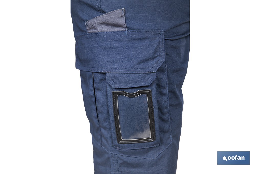 Bermudas de trabajo modelo Tyr en azul marino y negro | Elásticas, ligeras con múltiples bolsillos y protección lumbar| Materiales: 65 % poliéster y 32 % algodón | Disponibles en amplio rango de tallas - Cofan